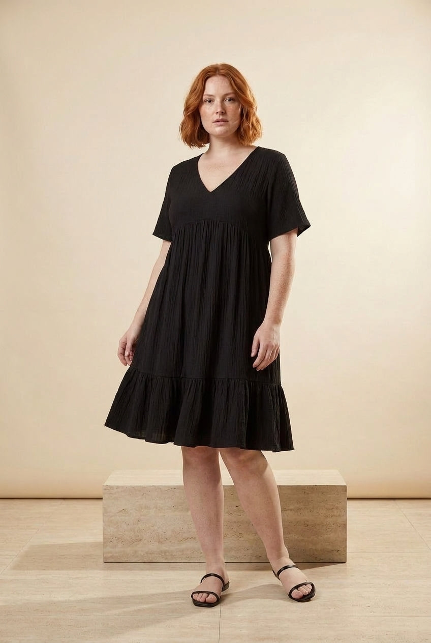 Relaxed V-Neck Ruffle Hem Mini Dress in Black, three-quarter view – Petopet